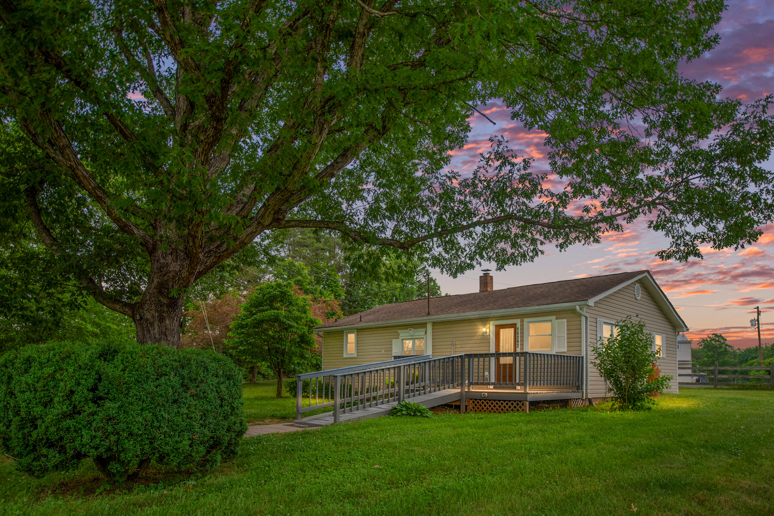 One story home surrounded by large trees for sale in Orange VA.